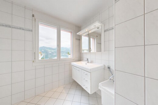 bathroom featuring tile walls, vanity, and light tile patterned floors