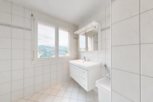 bathroom featuring tile walls, vanity, and light tile patterned floors