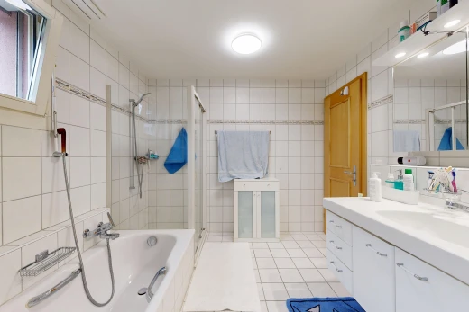 bathroom featuring tile walls, a bath, vanity, a stall shower, and light tile patterned floors
