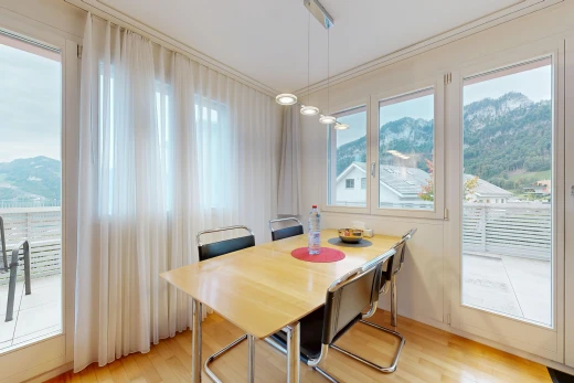 dining space with access to outside, a mountain view, light wood-style floors, and crown molding