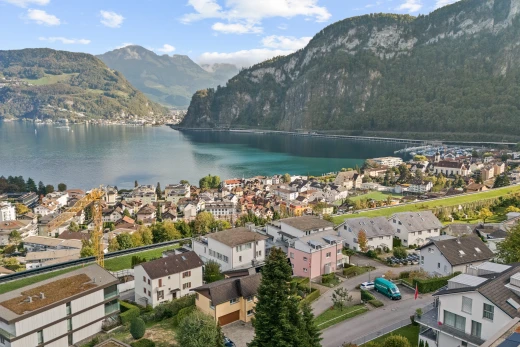 water view with a mountain backdrop and nearby suburban area