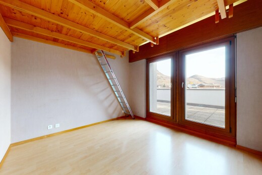 spare room featuring light wood-style floors and a wooden ceiling with exposed beams
