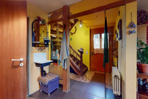 hall / corridor with radiator heating unit and dark tile patterned flooring