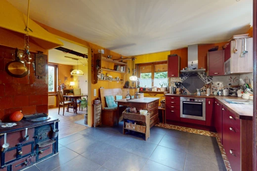 kitchen featuring decorative light fixtures, appliances with stainless steel finishes, plenty of natural light, and wall chimney range hood