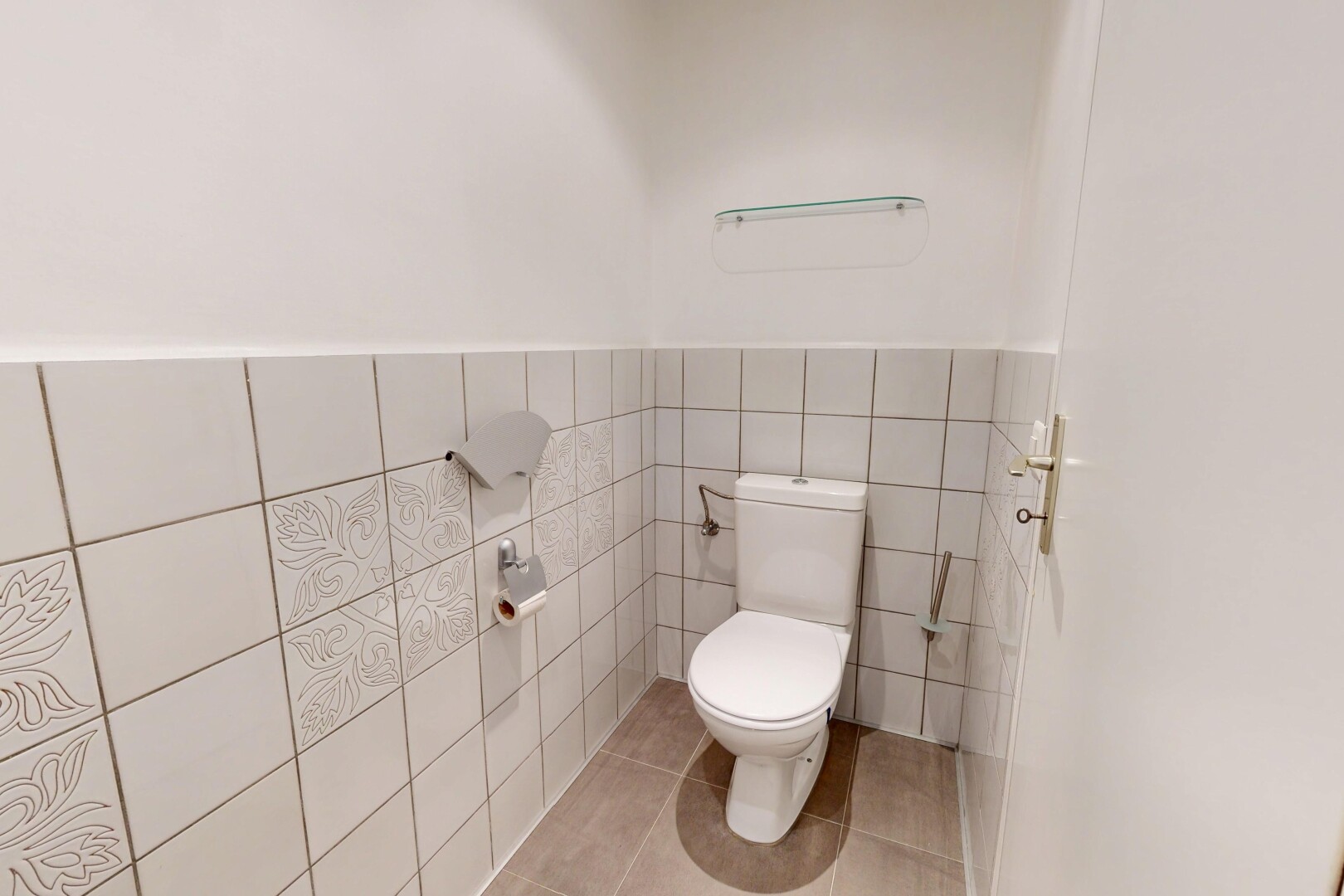 bathroom featuring tile walls, light tile patterned flooring, and a wainscoted wall