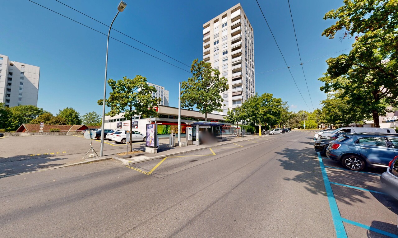 view of property featuring street lights and curbs