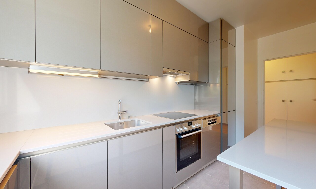 kitchen with light countertops, oven, modern cabinets, black electric cooktop, and gray cabinetry