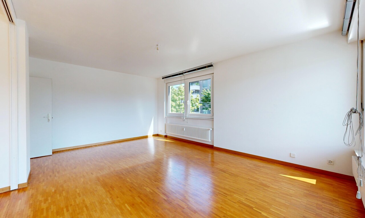 empty room featuring radiator heating unit and light wood-style flooring