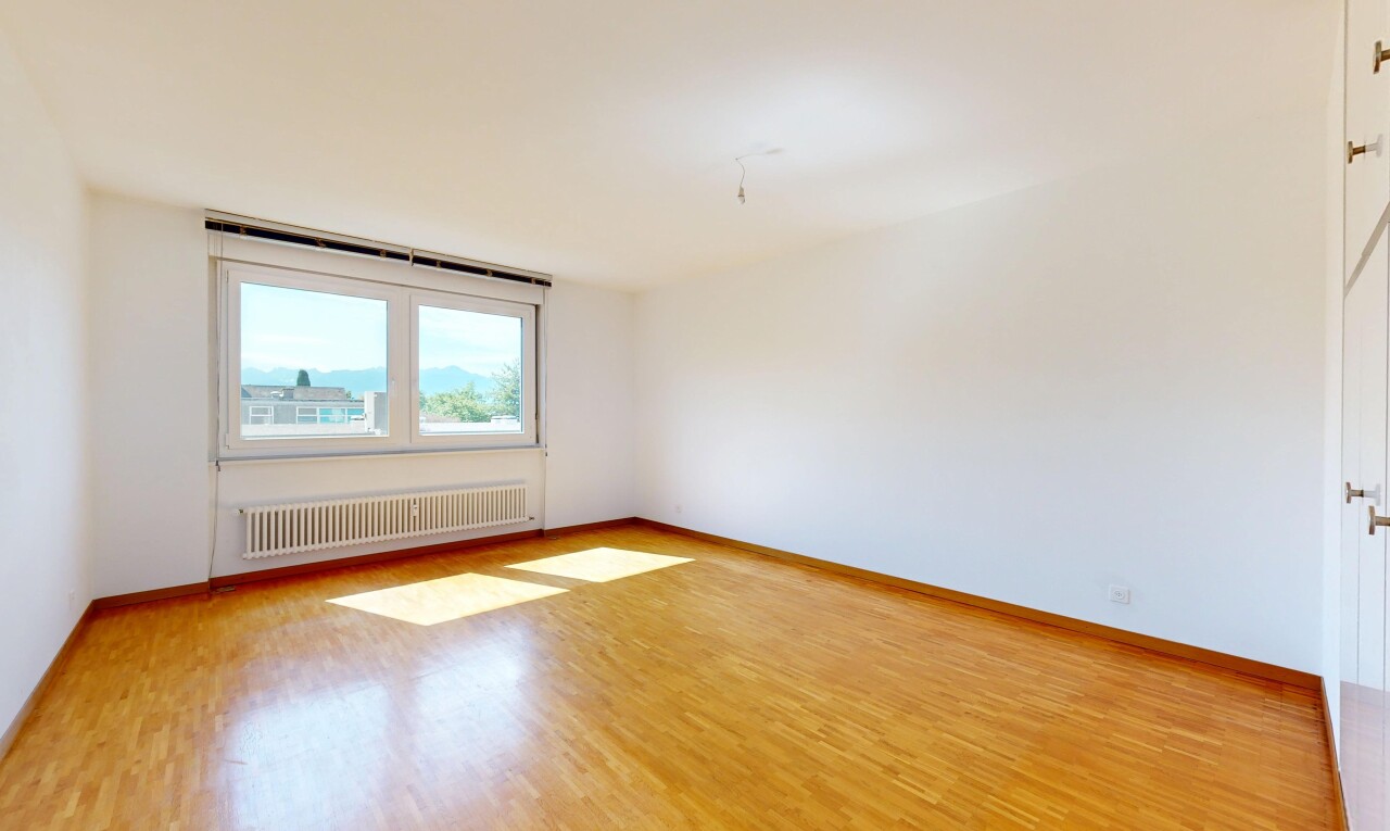 unfurnished room featuring radiator and light wood-style floors