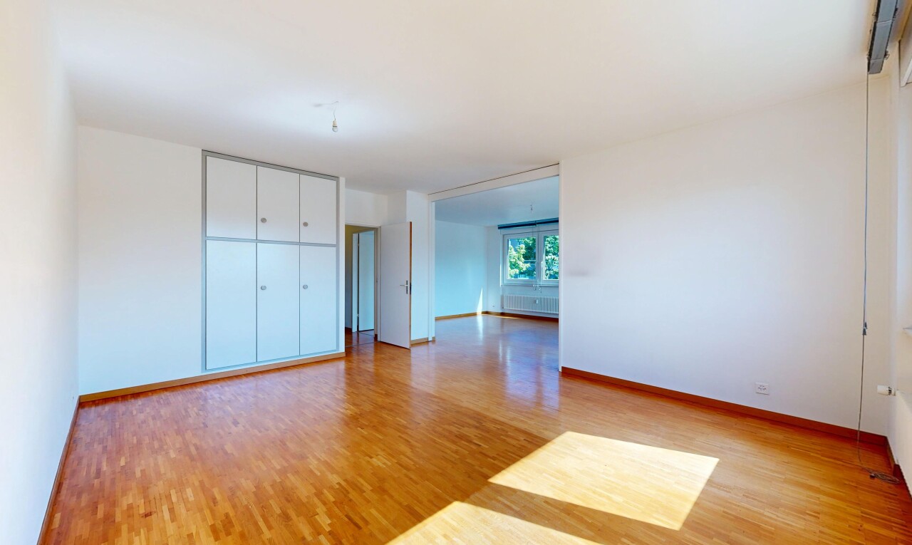 spare room with light wood-type flooring and baseboards