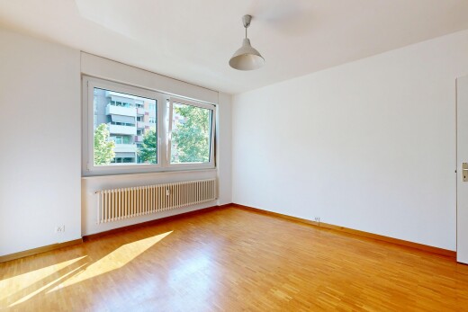 spare room with radiator, decorative light fixtures, and light wood-style floors
