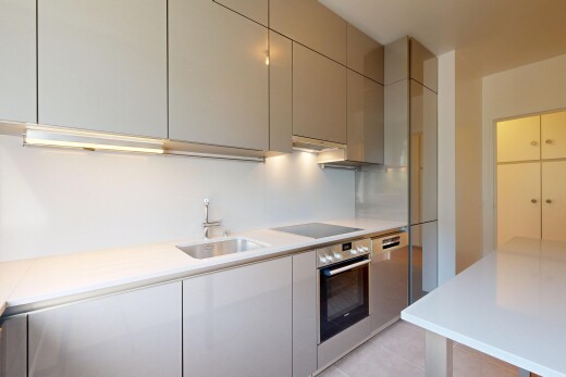 kitchen with light countertops, oven, modern cabinets, black electric cooktop, and gray cabinetry