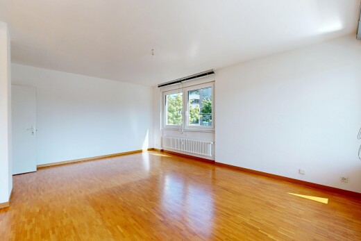 empty room featuring radiator heating unit and light wood-style flooring