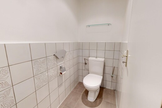 bathroom featuring tile walls, light tile patterned flooring, and a wainscoted wall