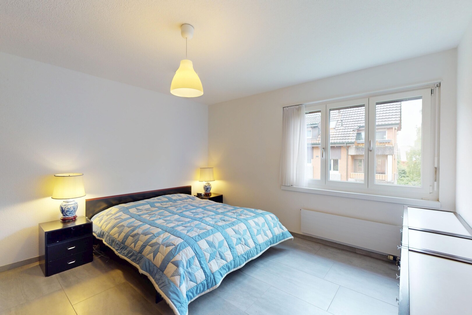 room featuring multiple windows and radiator