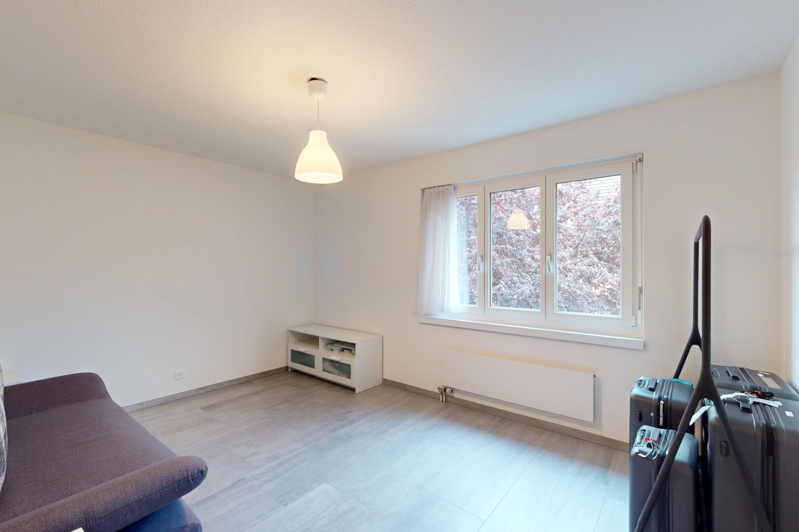 living area with radiator and wood finished floors
