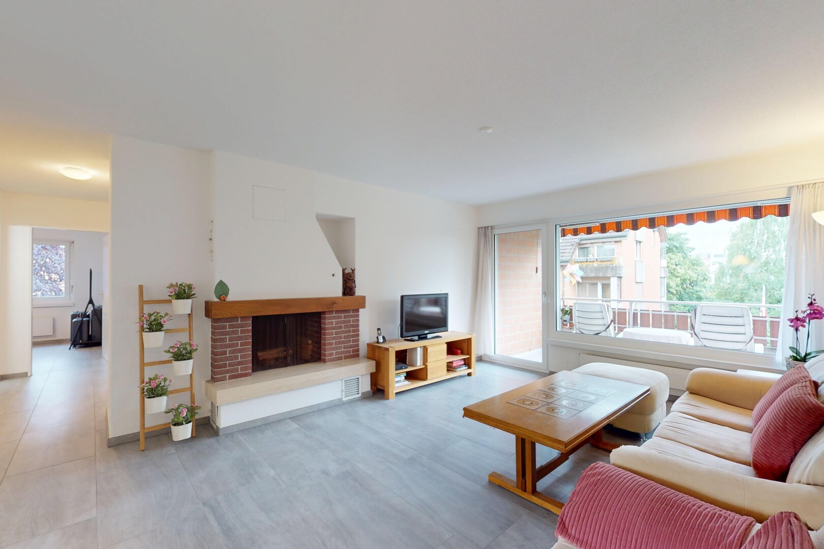 living area with a brick fireplace
