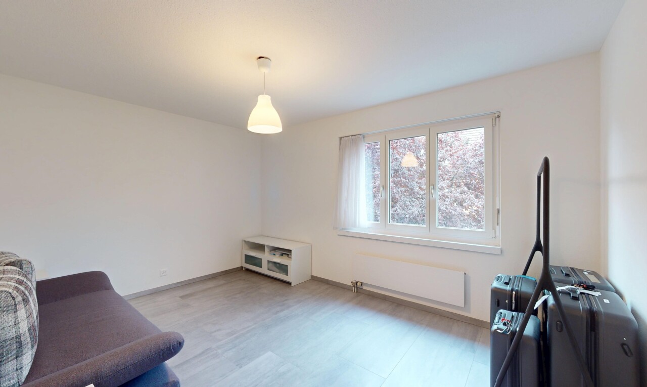 living area with radiator and wood finished floors