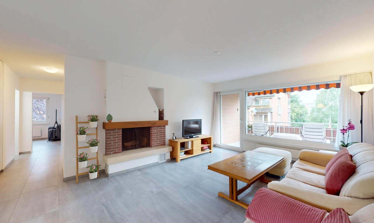 living area with a brick fireplace