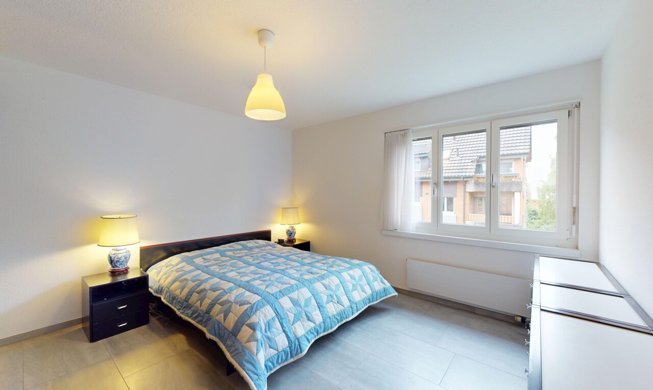 room featuring multiple windows and radiator