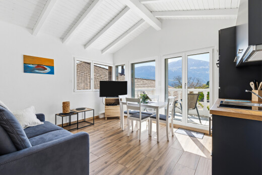 salon / salle à manger avec cloison sèche, drywall, lumière naturelle, natural light, et sol en finition bois