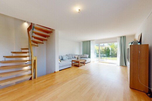 salon avec escaliers, cloison sèche, drywall, sol en finition bois, et wood finish floor