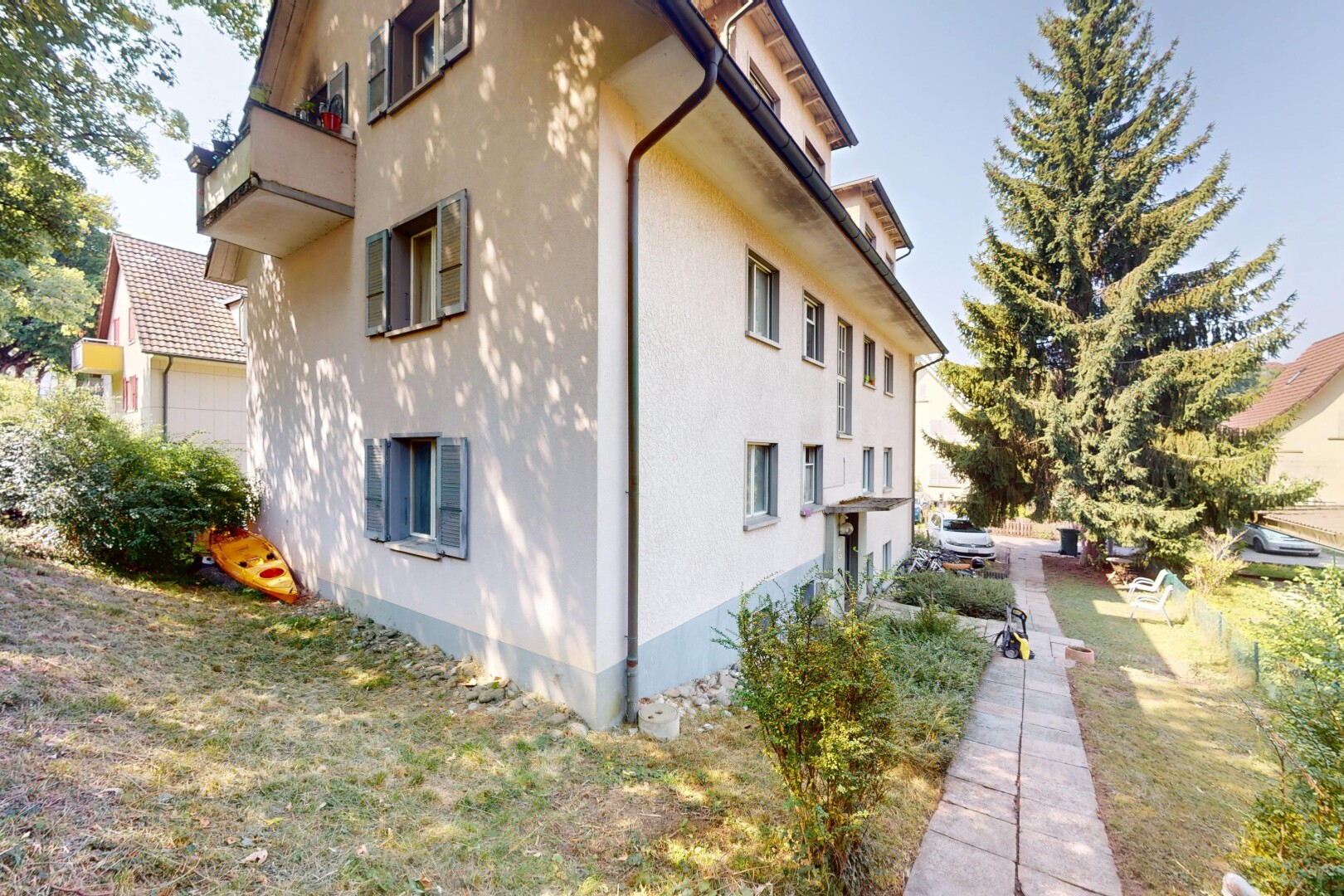 außenansicht mit property visible, stuckverkleidung, day time, betonfundament, und rasen