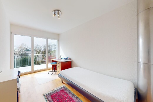 chambre avec lumière naturelle, cloison sèche, accès à l'extérieur, et sol en finition bois