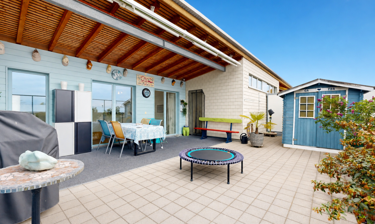 patio / terrace with outdoor dining area, a patio, and an outbuilding