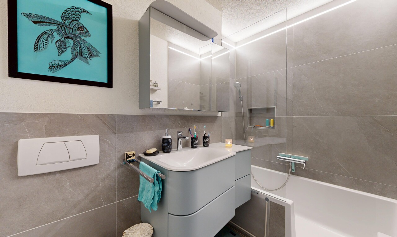 full bathroom featuring vanity and tile walls