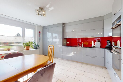 küche mit natürliches licht, arbeitsplatten, schränke mit flachen paneelen, küchenrückwand beim herd, und ofen