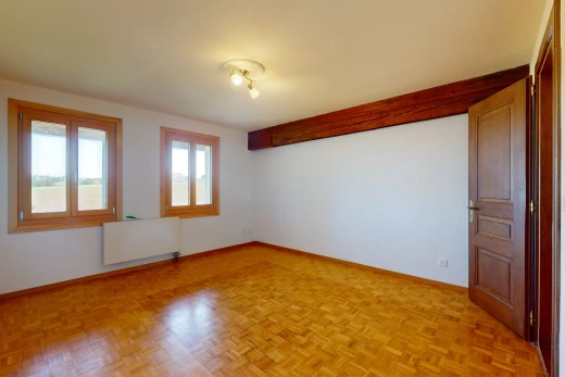 pièce vide avec radiateur, parquet, et lumière naturelle