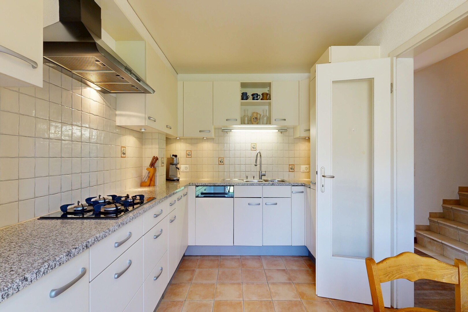 cuisine avec hotte, light countertops, inside property, backsplash, et dosseret