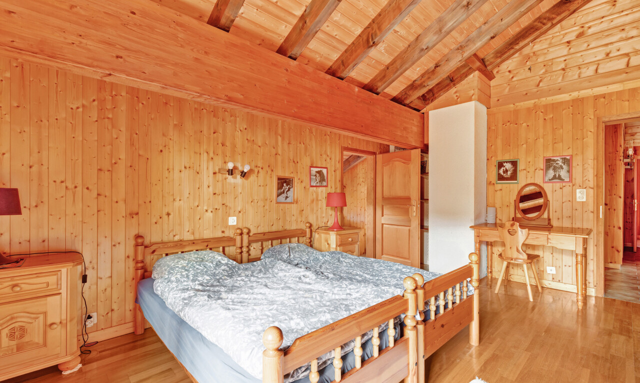 room / bedroom with a wood ceiling with exposed beams, wood walls, light wood-type flooring, and high vaulted ceiling
