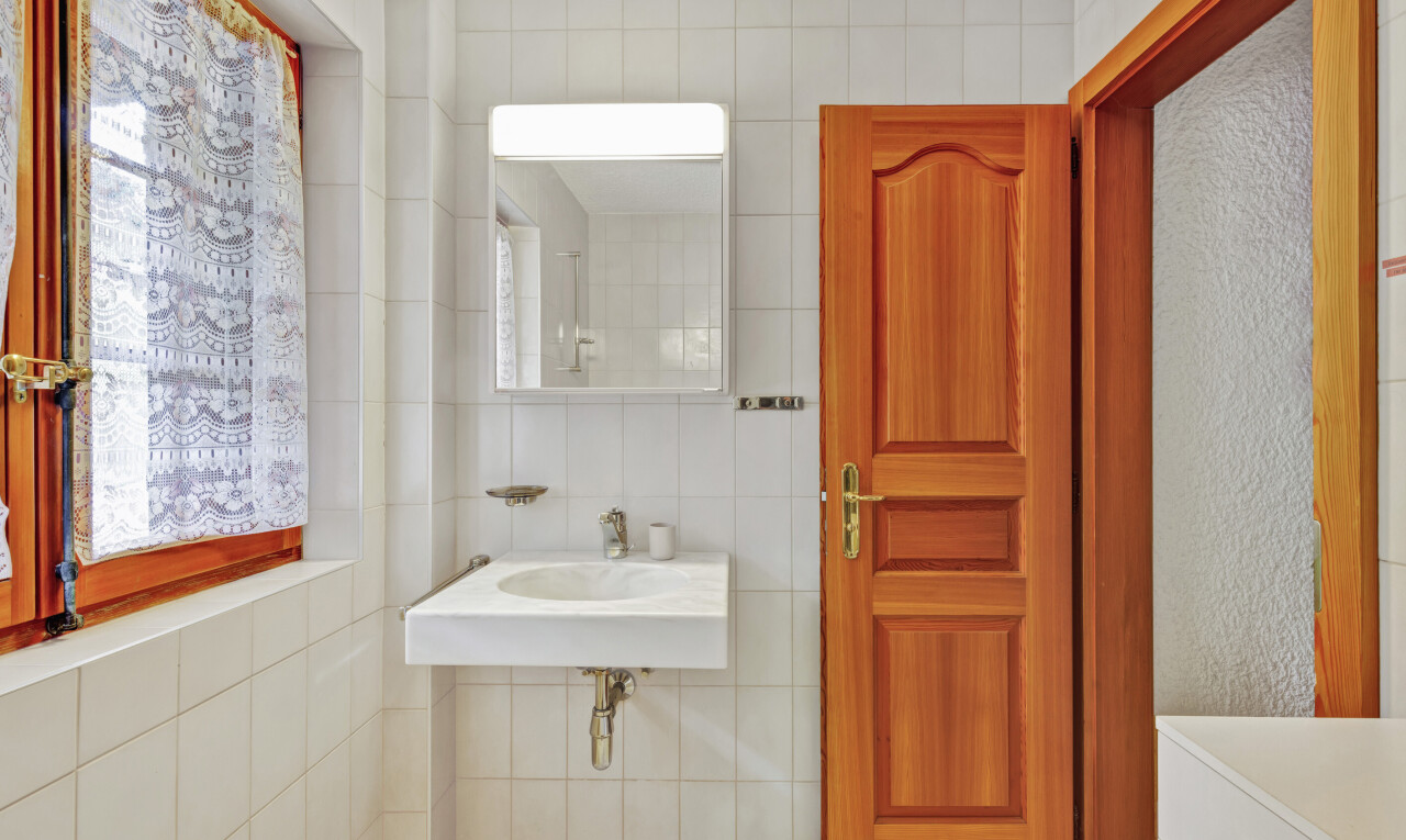 bathroom with tile walls