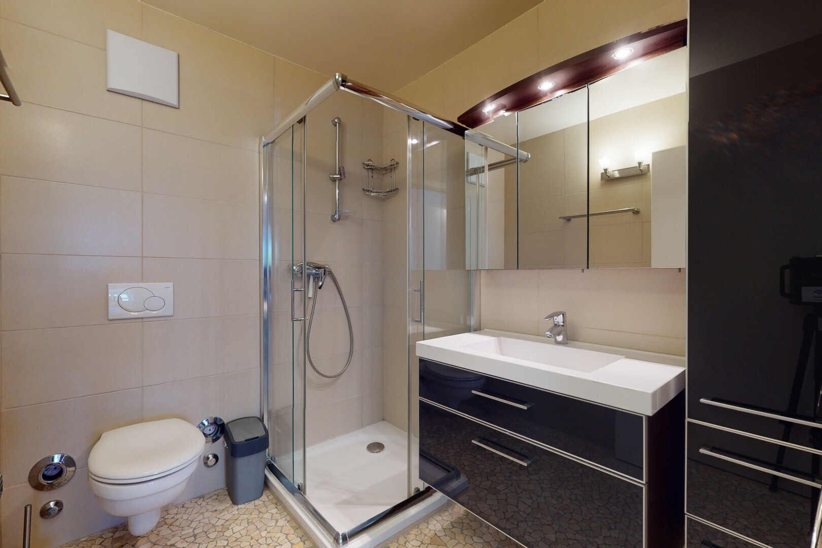 full bath with vanity, a shower stall, and tile walls