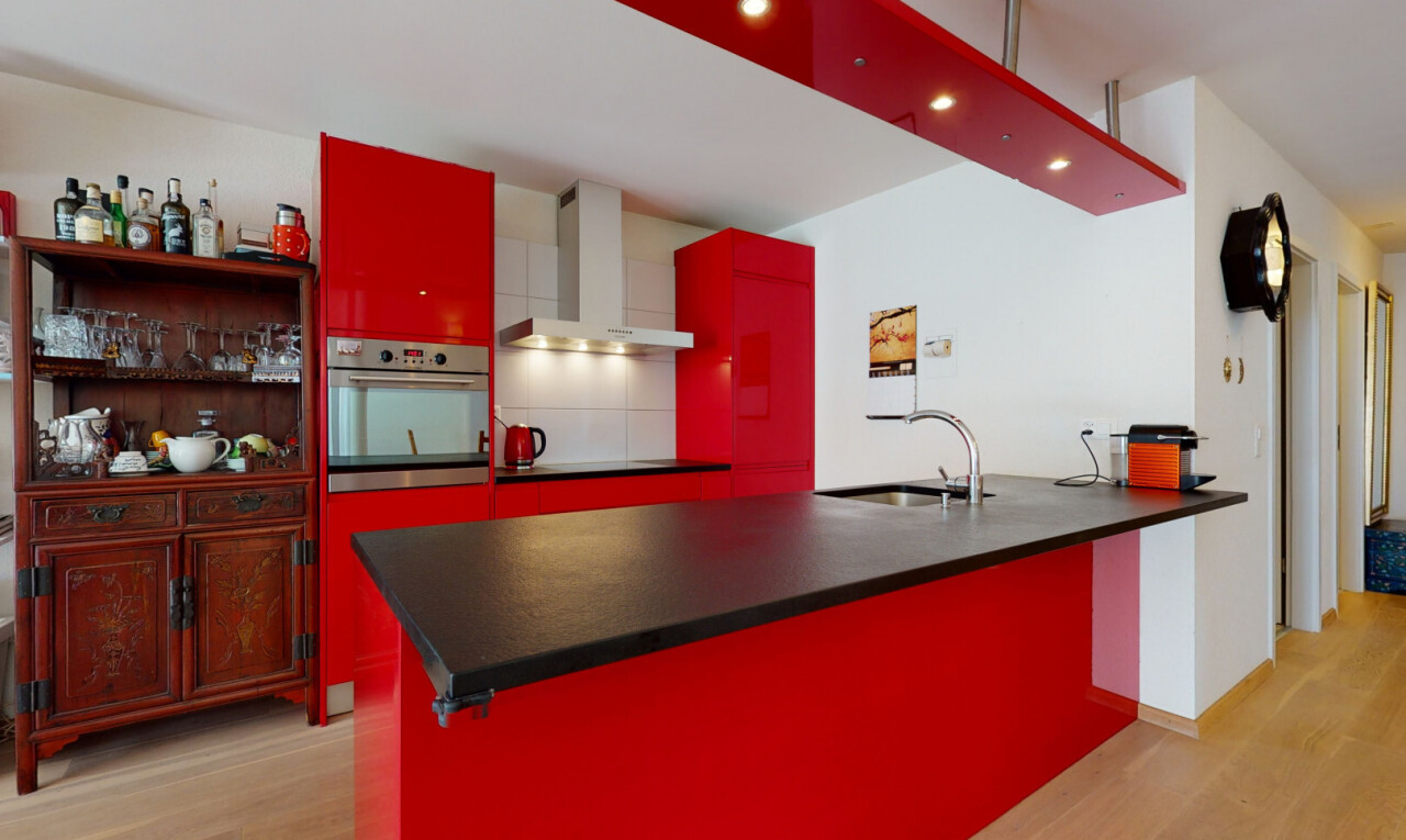 kitchen with oven, red cabinets, light wood-type flooring, and a peninsula