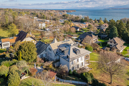 view of home featuring a residential view, a water view, and a balcony