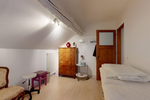 living area featuring light wood-type flooring, lofted ceiling, and radiator