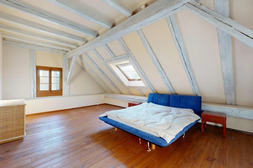 chambre avec plafond à poutres, beamed ceiling, hardwood floor, puits de lumière, et pièce supplémentaire