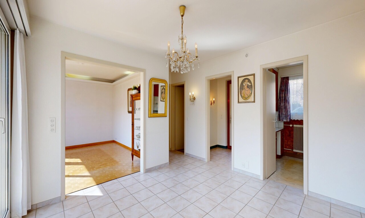 pièce vide avec lustre remarquable, drywall, cloison sèche, radiateur, et natural light