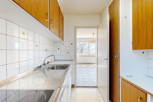 cuisine avec armoires marron moyen, medium brown cabinets, plans de travail, light countertops, et light floor