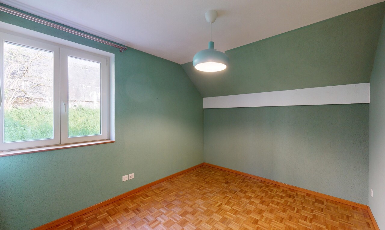 pièce vide avec plafond voûté, cloison sèche, plinthes murales, et lumière naturelle