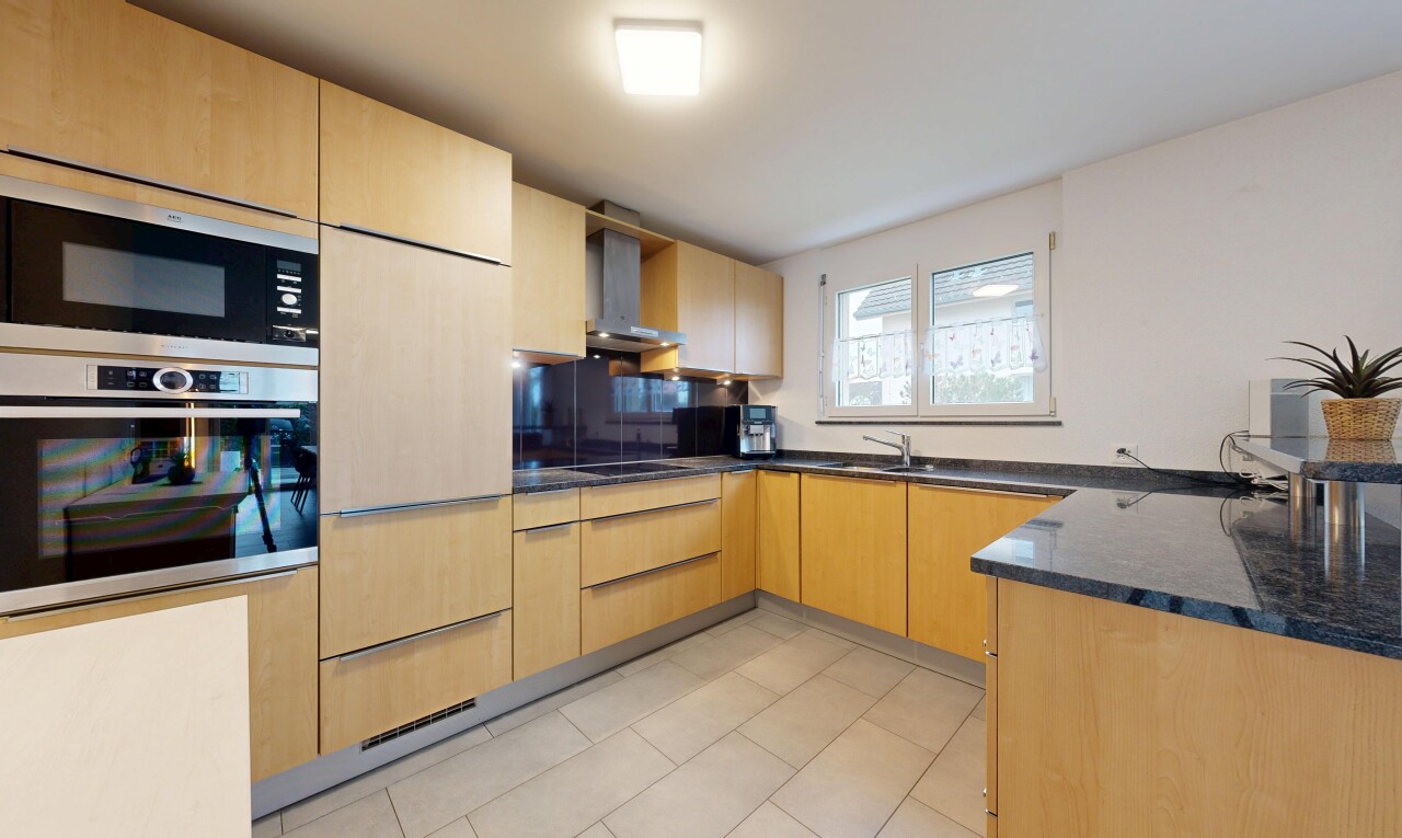 küche mit hellbraune schränke, light brown cabinets, ofen, dark countertops, und dunstabzugshaube