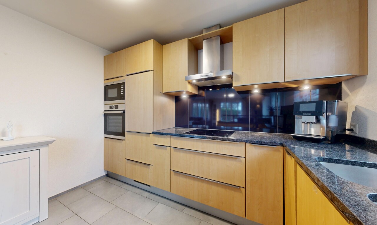 küche mit light brown cabinets, hellbraune schränke, stone countertops, stein arbeitsplatten, und dunstabzugshaube