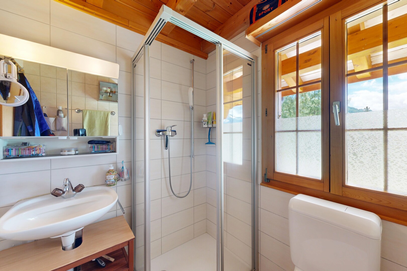 bathroom featuring a shower stall and tile walls