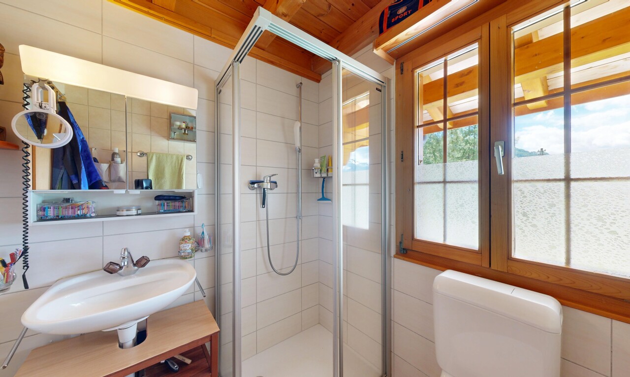 bathroom featuring a shower stall and tile walls