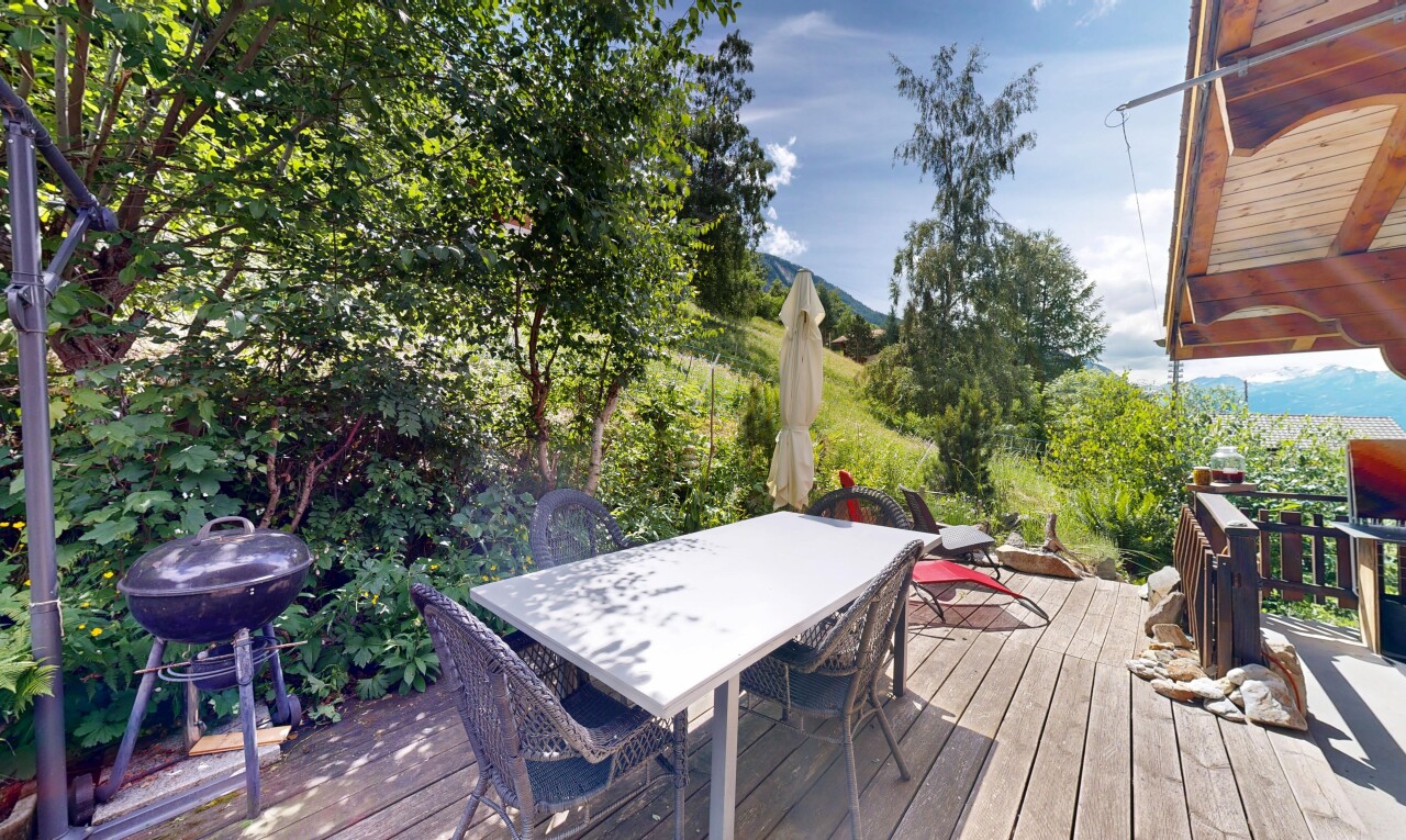 view of wooden deck with outdoor dining space and grilling area