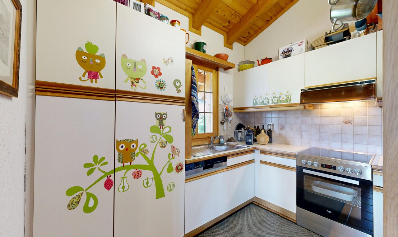 dual tone kitchen with electric stove, light countertops, wooden ceiling, backsplash, and lofted ceiling with beams