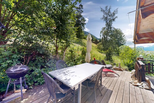 view of wooden deck with outdoor dining space and grilling area